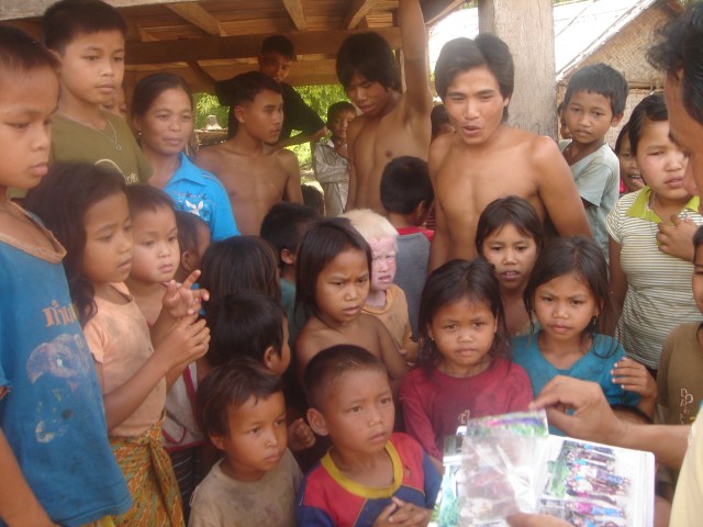 Somdy bringing photos to the village he'd taken on an earlier trip