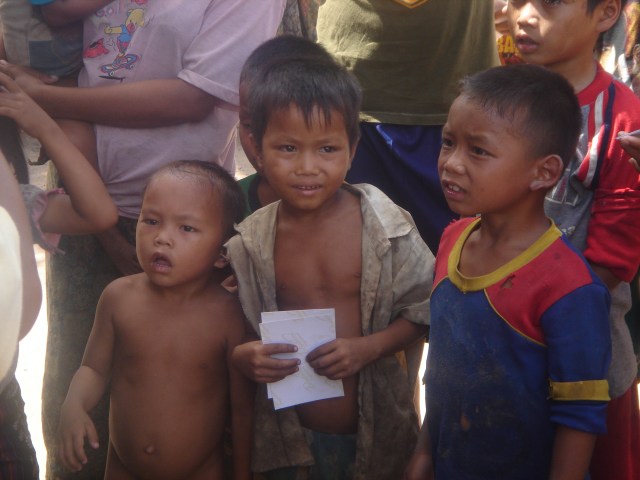 Village children in their threadbare clothes