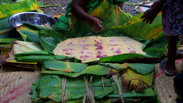 local women prepare a feast with mushed banana, coconut and chicken