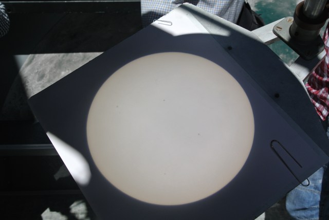 The Sun's projection, complete with sunspots (the dark dots)
