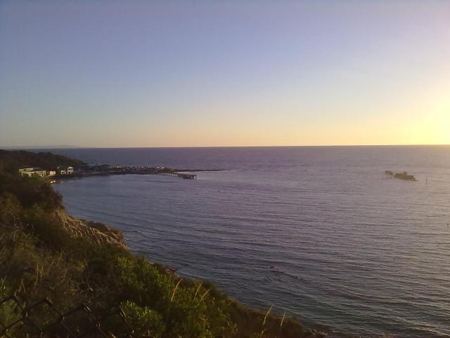 Views of the yacht club, with the wreck of the Cerberus in the water