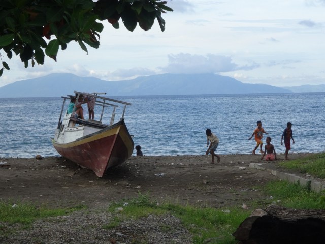 Children play on the beach outside Dili