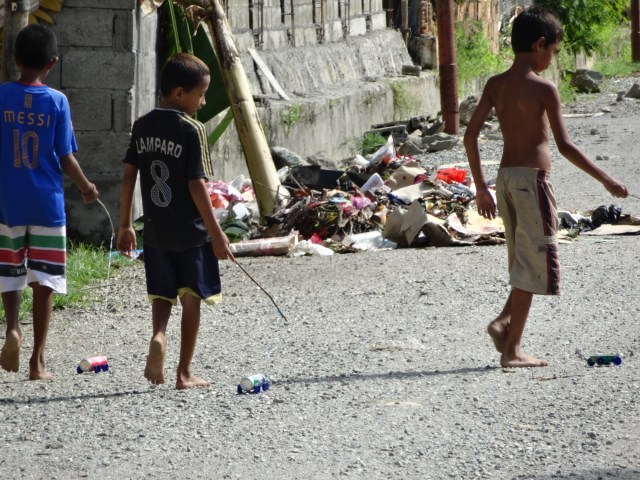 Local boys show off their ingenuity with toy cars, home made from cans and bottle caps