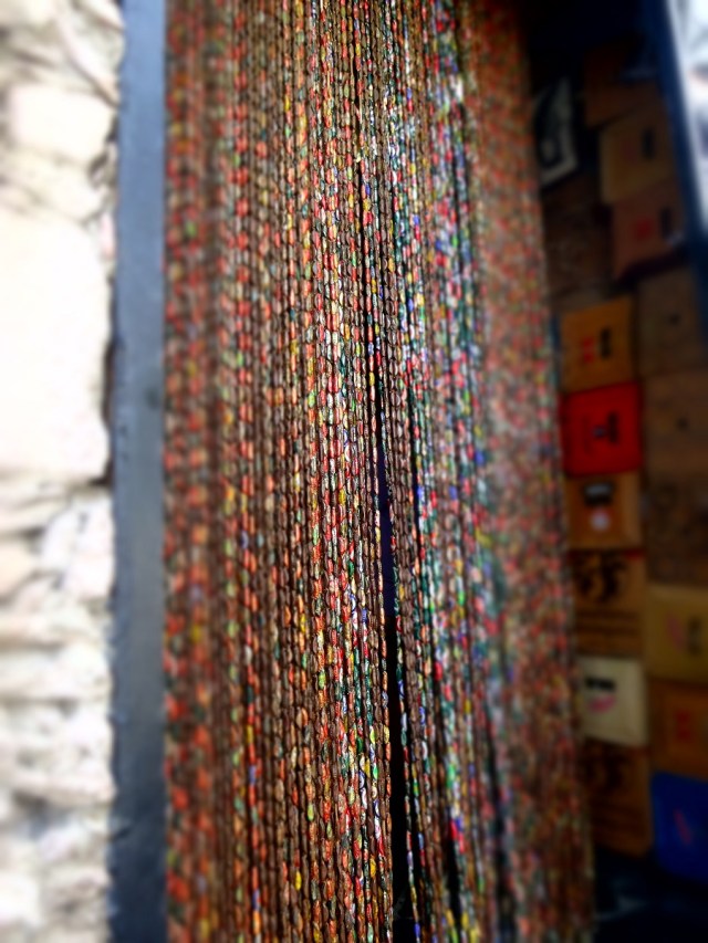 Creatively using beer bottle caps to make a fly screen!