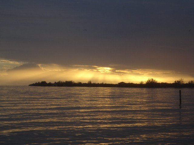 A glimpse of the sun with showers in the distance